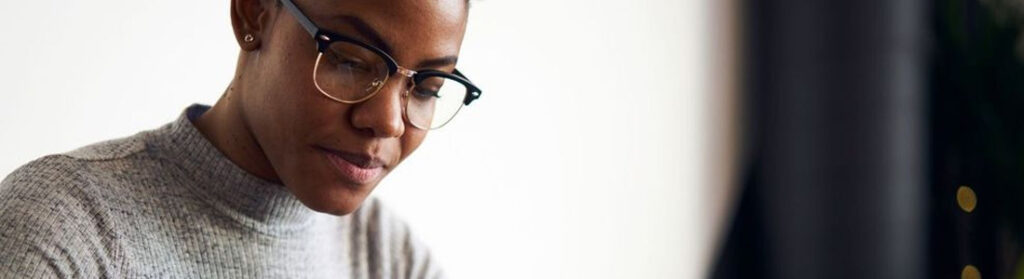 Professional woman looking down at her desk.