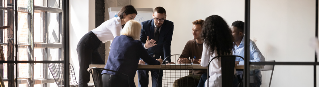 Diverse work team engaged around a table.